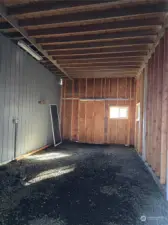 Large end storage area in the garage - potential, if a door is added, for RV storage, buyer to measure,