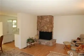 The living room has a fireplace and hardwood floor. Nice open floor plan.