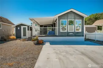 Nice parking, vinyl siding, built in 2001 and is 500 sq. ft. +/-. It is utilized as a 2 bedroom and 1 bath. Covered composite deck area and generous outbuilding.