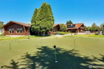 Putting green. There are three buildings side by side.