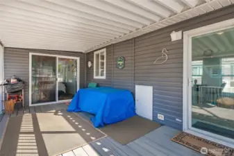 Spacious covered deck area. See sliding patio door to the extra bedroom area.