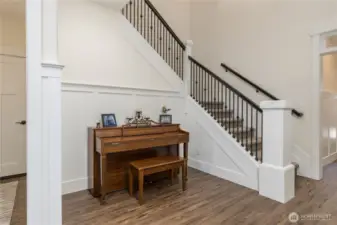 Elegant touches throughout, including wainscoting and iron balusters