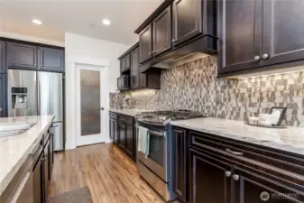 Designer tile backsplash, and note the convenient walk-in pantry!