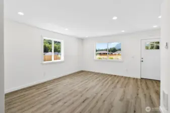 View of front door from far side of living room.
