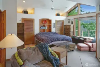 The primary bedroom suite also offers high ceilings, a ceiling fan, and an attached bath around the corner to the left not shown in the photo.