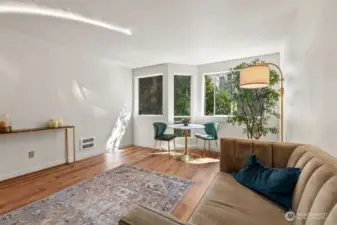 Sunlight dapples in, softened by a canopy of lush greenery just beyond the glass, filling the space with the quiet beauty of a canopy retreat