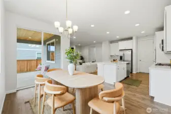 Kitchen and dining area open to fenced back yard and covered patio
