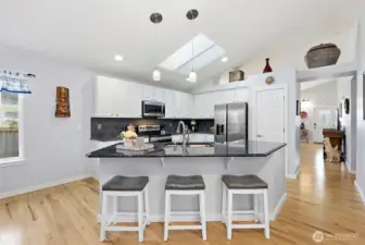 Large kitchen with slab countertops, SS appliances and pantry