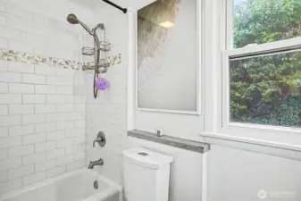 Classic subway tile surrounds the tub/shower for timeless charm.