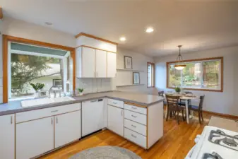 Kitchen has oak floors, lots of counter and cabinet space, a bay window and gas stove.