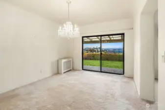 Dining Room with Outside Seating has Panoramic View and Oak Hardwood Flooring Underneath the Carpet.