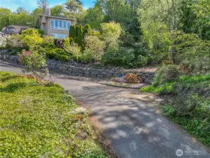 Building site drive way into lot next to this beautiful view home at end of the rock wall gets you into your 1.79 mostly flat ready to build view site.  Houses values are very high in this area
