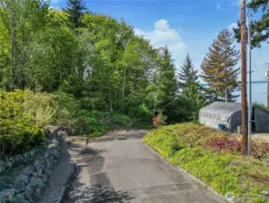 Entry road view with sound views to the right from property