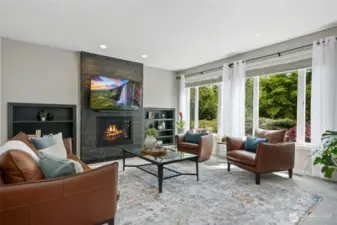 Family room with slate surround gas fireplace overlooking the back yard landscaping.
