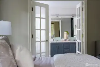 Double French door access to the Master Bath featuring  Designer sinks and Marble floors and counters