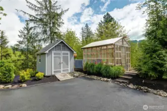 Another view of the Green house and Storage shed for all your lawn and garden tools. Pictured between them is the gas on-demand Whole House Generator.