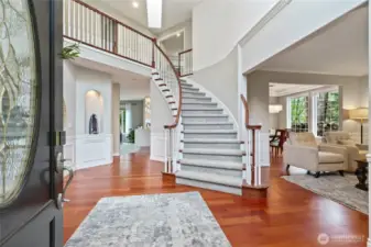 The Grand entry with dramatic staircase and high ceilings invites you in. Rich hardwood floors and traditional wainscoting blended together.