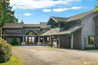 Gracious forecourt with shop/garage on right. Upper level is the partially furnished storage area with some plumbing installed for future kitchen and bath.