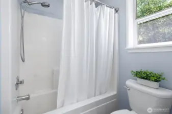 Primary bedroom suite upstairs with full bath and walk in closet.