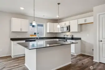 Open Concept living/Dining/Kitchen-Disclaimer- Photos are from a similar floor plan from another community, photos are for illustrative purposes only. Finishes, flooring, features, upgrades, countertops, paint, colors, and other features may vary.