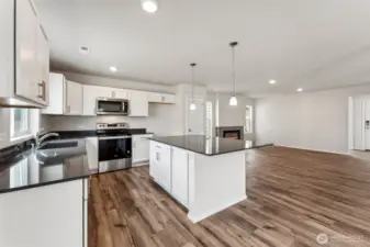 Open Concept living/Dining/Kitchen-Disclaimer- Photos are from a similar floor plan from another community, photos are for illustrative purposes only. Finishes, flooring, features, upgrades, countertops, paint, colors, and other features may vary.