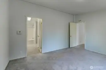Primary bedroom with full ensuite bath and walk-in closet.