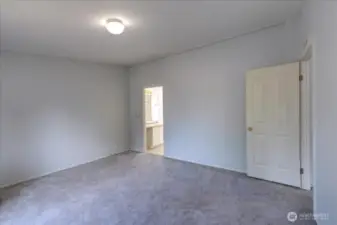 Another view of the primary suite - roomy and at the opposite end of the other two bedrooms.