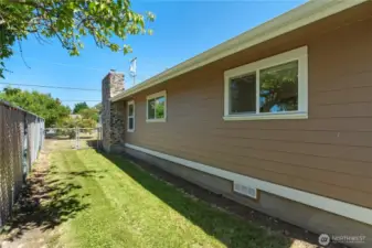 Side yard with fenced dog run