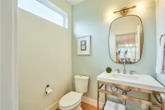 Rounding out the main floor is a stylish half bath, perfect for guests.