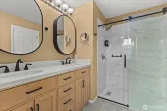 Remodeled Primary bath w/ walk-in-shower & double vanity.