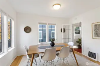 The gorgeous dining room with the tudor style archway and leaded glass paned windows and door to the kitchen.