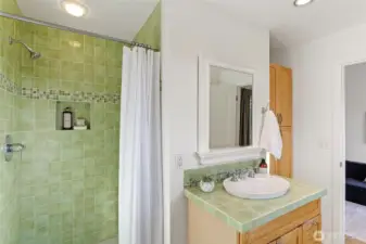The shade of seagrass gives this upstairs bathroom a beautiful glow, with a walk-in shower and linen cupboard, its shared by both upstairs bedrooms.