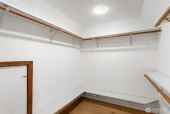 The primary bedroom walk-in closet with easy access to 2 attic spaces for extra dry storage.
