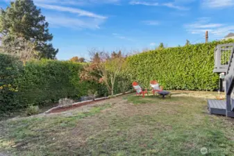 Freshly landscaped and full of character, this classic Tudor  shines with white stucco, black trim, and timeless curb appeal. A small back landing opens to the  tiered backyard—perfect for enjoying a morning coffee or tending the garden. With a dedicated  parking spot, new outdoor outlet for electric car charging, and a tidy garden shed, every detail  outside feels both functional and inviting.