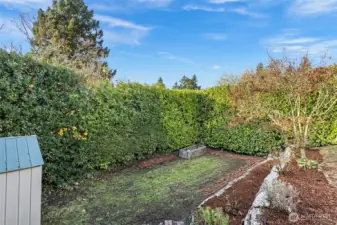 Freshly landscaped and full of character, this classic Tudor  shines with white stucco, black trim, and timeless curb appeal. A small back landing opens to the  tiered backyard—perfect for enjoying a morning coffee or tending the garden. With a dedicated  parking spot, new outdoor outlet for electric car charging, and a tidy garden shed, every detail  outside feels both functional and inviting.