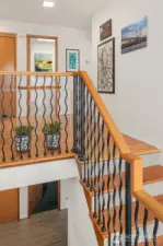 Unique Foyer with Tile entry, hardwoods & iron railing