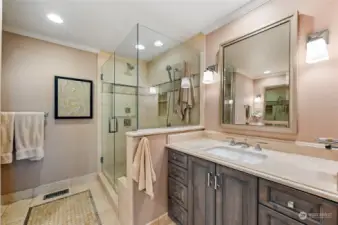 Lux en-suite bath with separate vanities, tiled step-in shower and heated basket weave tiled floor.