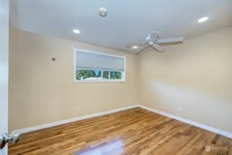 Upper primary bedroom with ceiling fan.