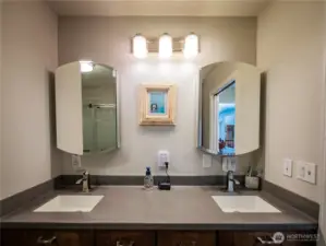 PRIMARY BATH...DUAL SINKS AND BIG SHOWER BEHIND... CORIAN COUNTER TOPS