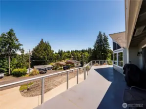 DECK IS SO LARGE...YOU COULD HAVE A FULL SIZE DINING TABLE DOWN AT THE END...A SUNBATHING STATION IN THE MIDDLE PART...AND A LITTLE COFFEE AREA JUST OUTSIDE THE FRENCH DOORS WHERE WE'RE STANDING