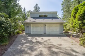 Detached 2 car garage is extra deep, has separate shop space, and a bonus room above.