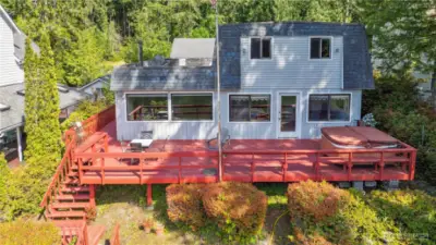 Windows across the main level and in two upper rooms provide 180 degree view of the water.