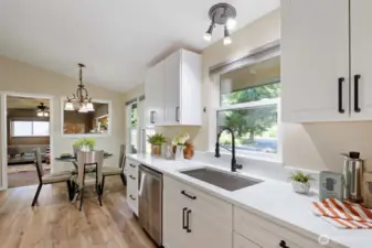Bright, smart, and welcoming, this kitchen packs a punch with dreamy front yard views from the kitchen sink!