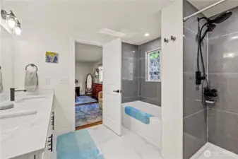 Primary bathroom with a full tub and walk in shower.