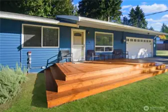 Freshly painted rambler with brand-new front deck, welcoming stairs to the lawn, and spacious two-car garage—great curb appeal near Bonney Lake.