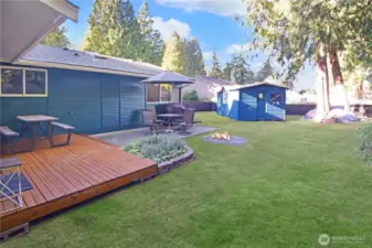 Fully fenced backyard with private deck, fire pit entertaining area, and oversized storage shed—outdoor living at its best near Bonney Lake.