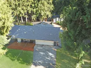 Aerial view of the freshly painted rambler with newer roof (approx. 5 years), front deck, and driveway—great curb appeal near Bonney Lake.