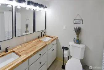 Full bathroom featuring brand-new butcher block epoxy-coated countertop—modern touch that enhances this updated Bonney Lake rambler.