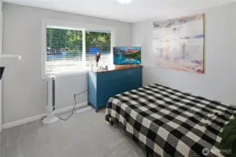 Second of three bedrooms with carpet and front-facing window—comfortable and versatile space in this Bonney Lake rambler.