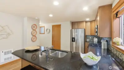 Spacious kitchen with lots of cabinet space + breakfast bar